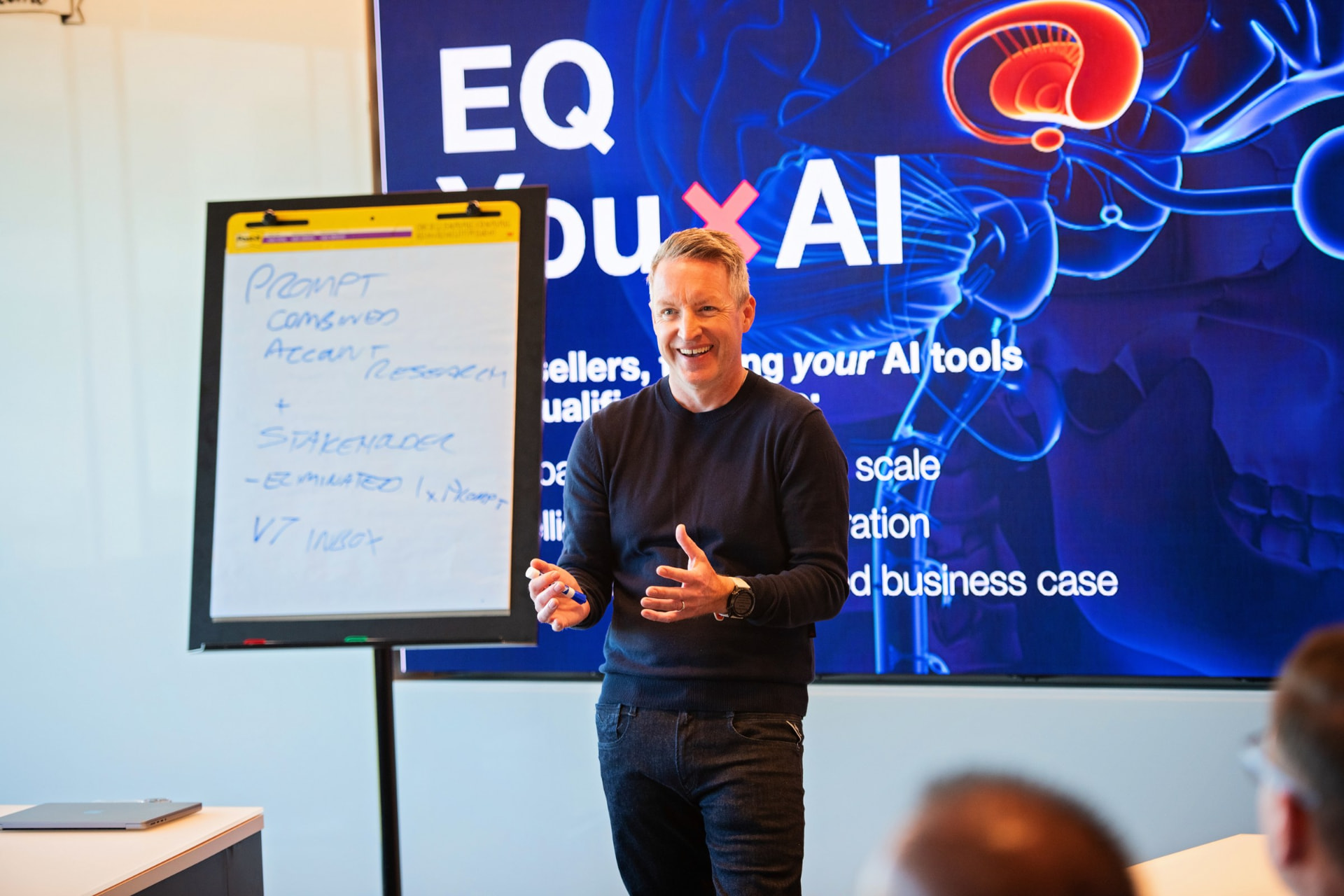 Ben Drakes delivering an eqai8 session, working at a flip chart with a customer team